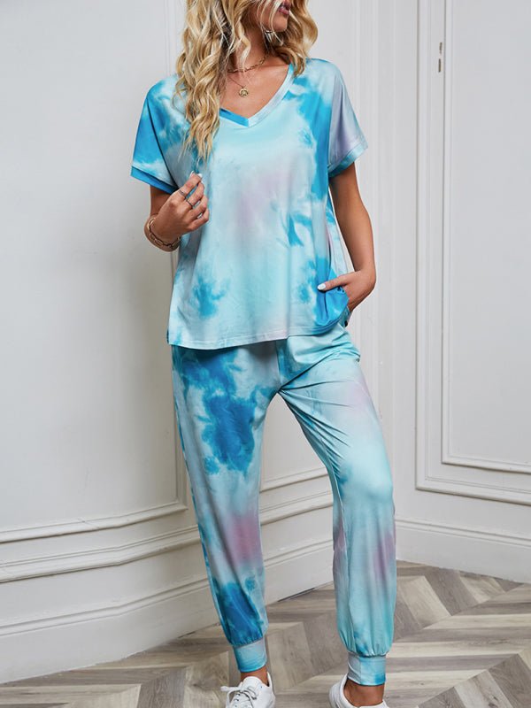 a woman in a blue tie dye top and pants