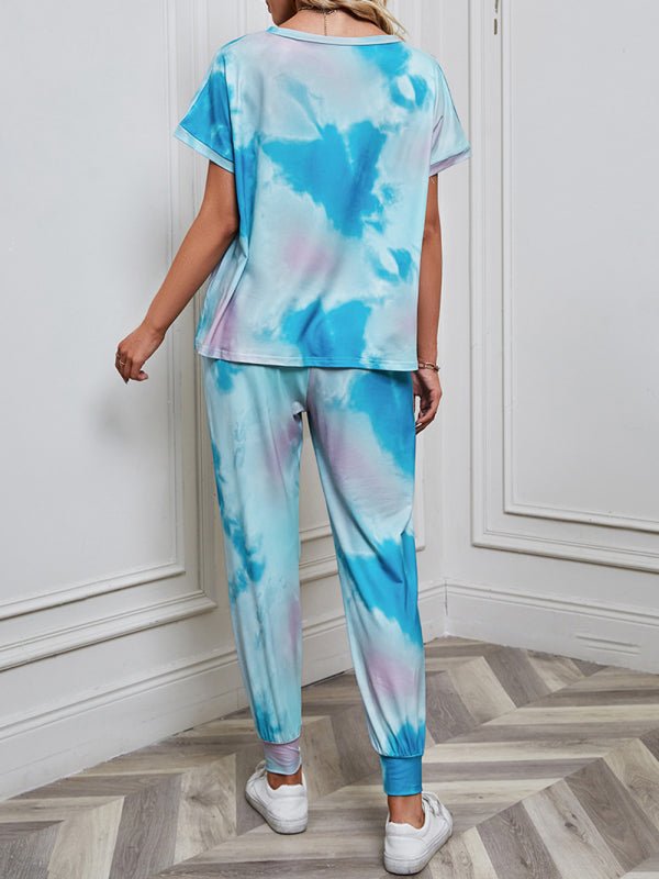 a woman in a blue and pink tie dye top and pants