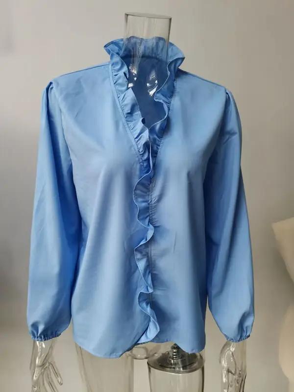 a mannequin wearing a blue shirt with ruffles