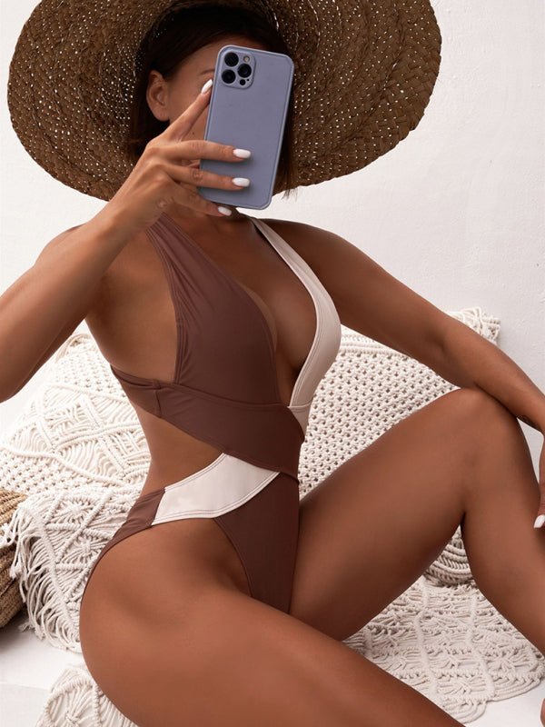 a woman in a bikini holding a cell phone