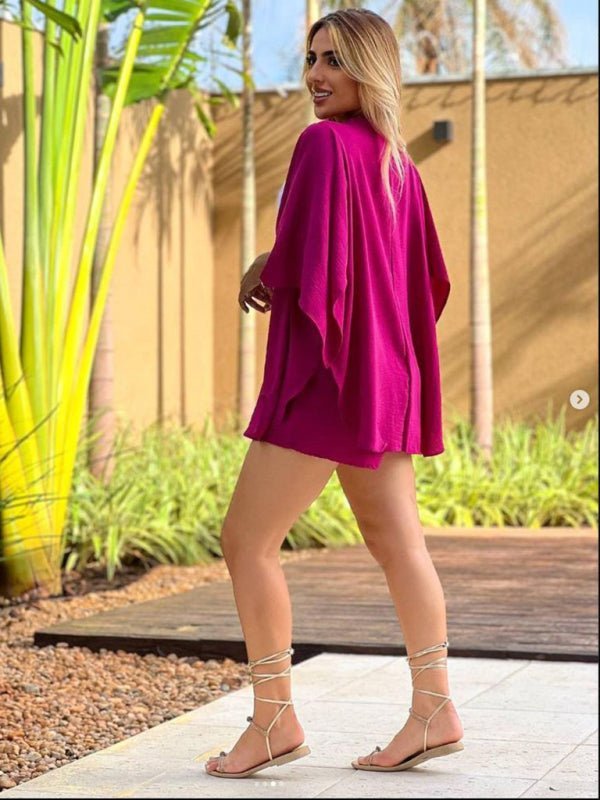 a woman in a pink dress is walking down a sidewalk