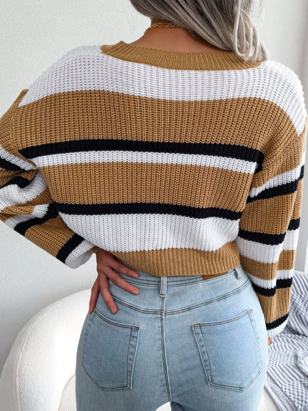 a woman wearing a brown and black striped sweater