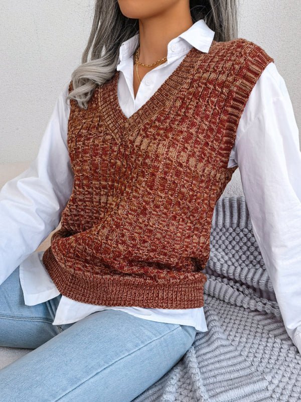 a woman sitting on a couch wearing a sweater vest