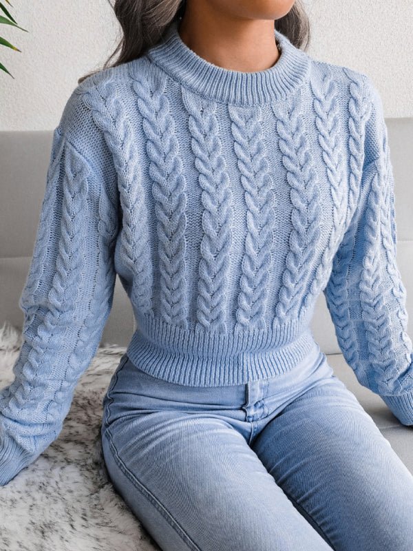 a woman sitting on a couch wearing a blue sweater