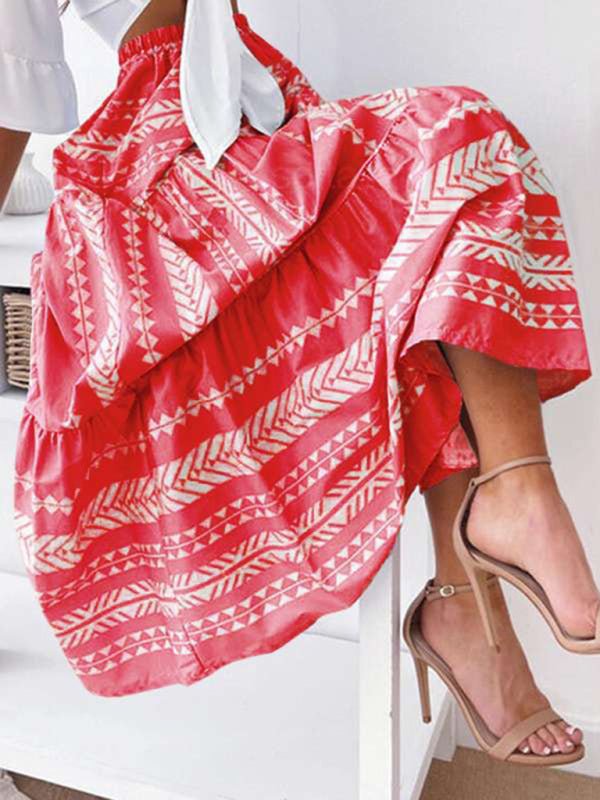 a woman in a red and white dress sitting on a white bench