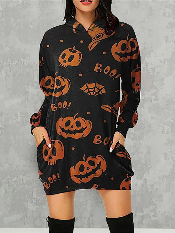a woman wearing a black and orange dress with pumpkins on it