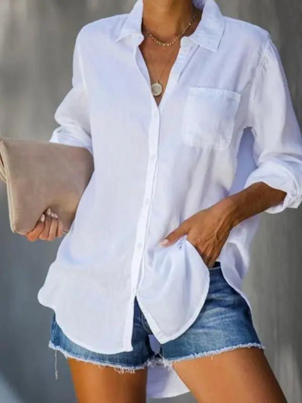 a woman wearing a white shirt and denim shorts