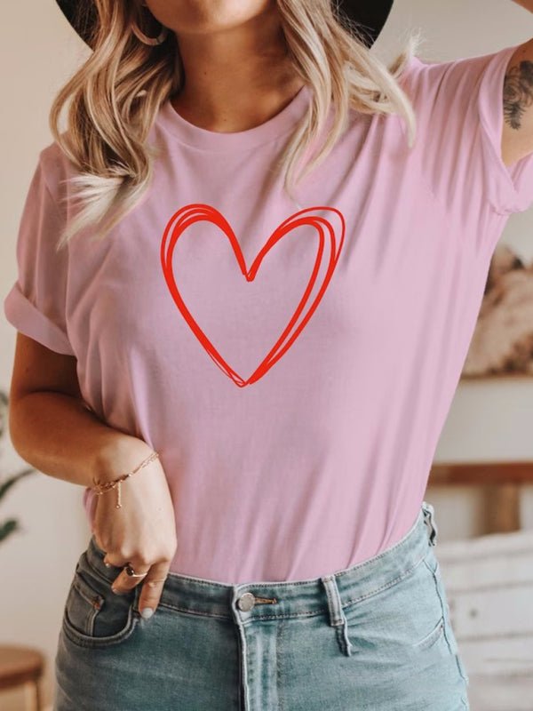 a woman wearing a pink shirt with a heart on it
