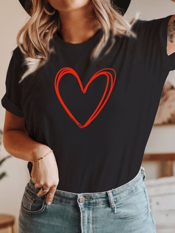 a woman wearing a black shirt with a red heart on it