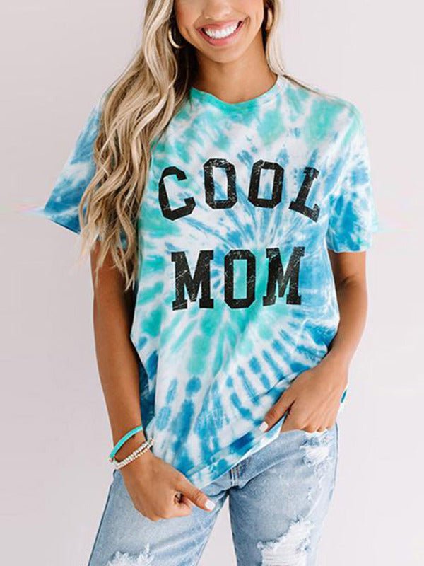 a woman wearing a tie dye shirt that says cool mom