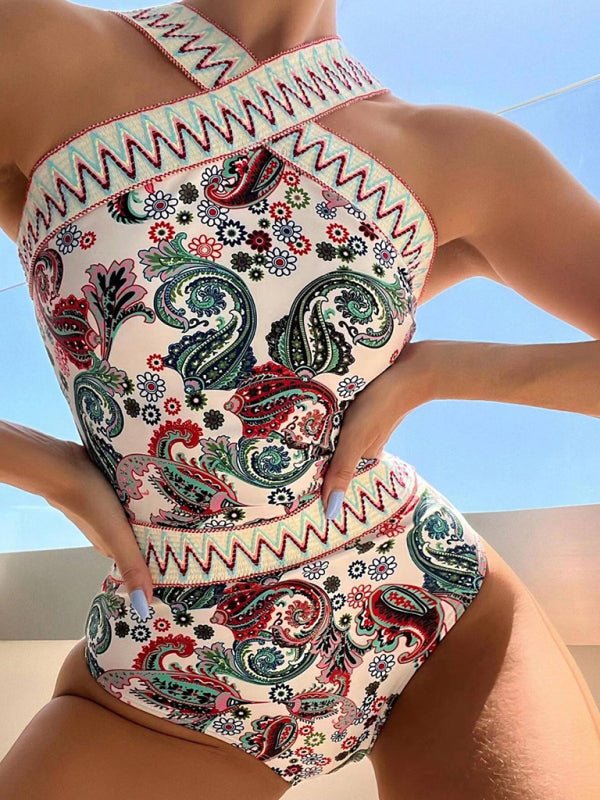 a woman in a paisley print swimsuit posing for a picture