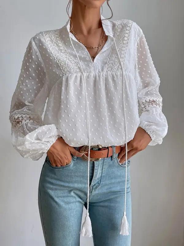 a woman wearing a white blouse and jeans