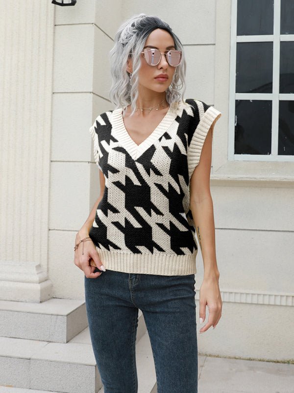 a woman with grey hair wearing a sweater and jeans