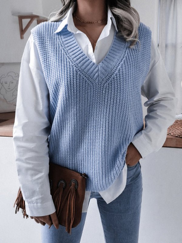 a woman wearing a blue sweater vest and white shirt