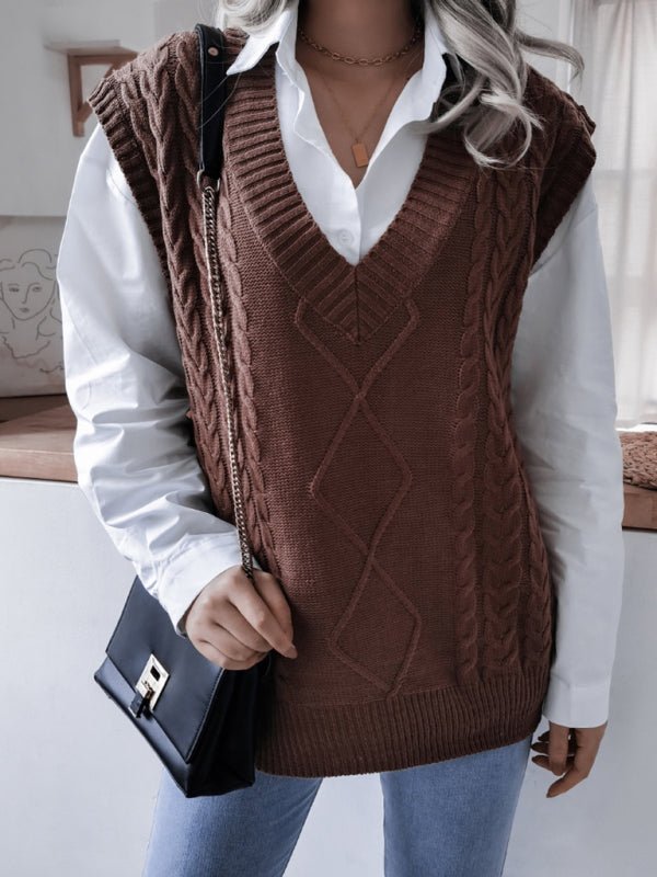 a woman in a brown sweater vest holding a black purse