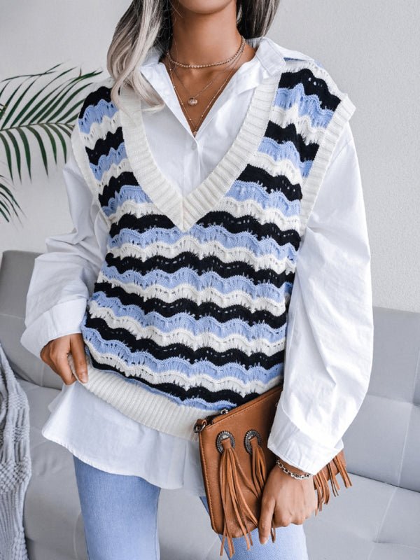 a woman wearing a white shirt and black and blue striped sweater