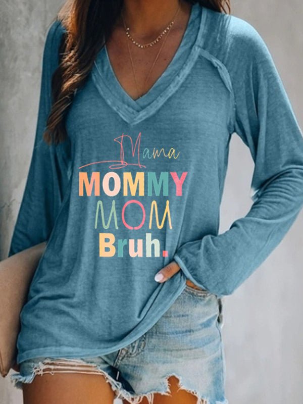 a woman wearing a blue shirt with the words mama on it