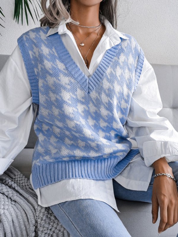 a woman sitting on a couch wearing a blue and white sweater