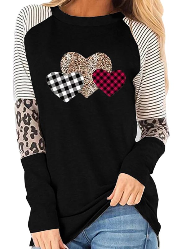 a woman wearing a black and white shirt with hearts on it